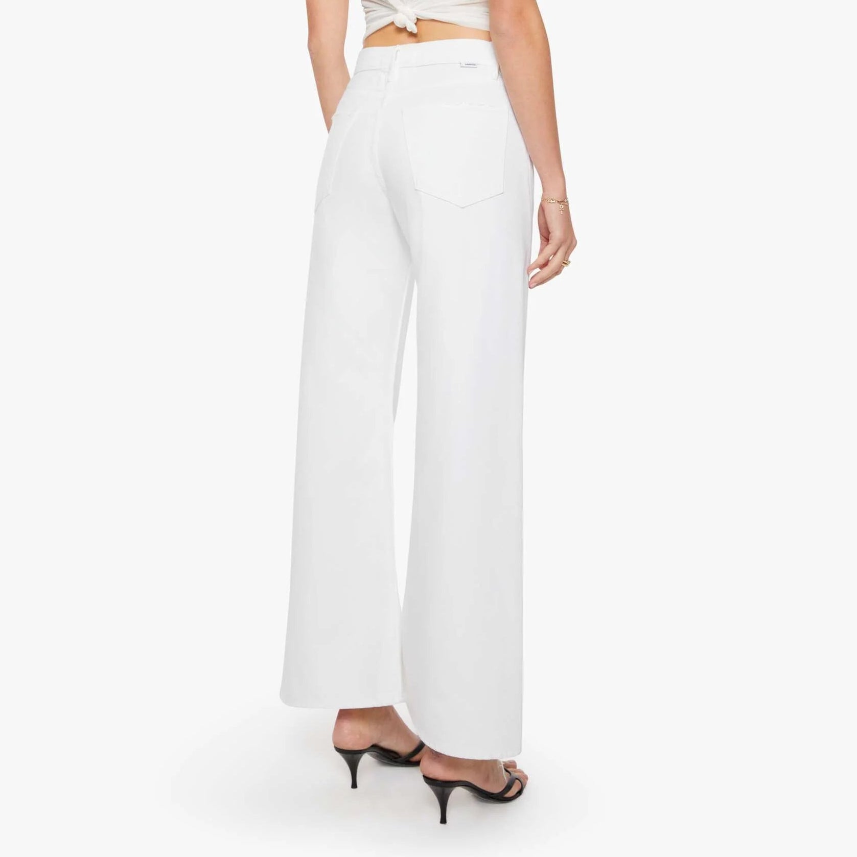 Woman wearing a white outfit with a blurred background