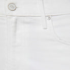 Close-up of white denim fabric with button and stitching details