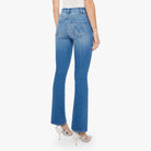 Woman wearing blue jeans and a white top on a white background