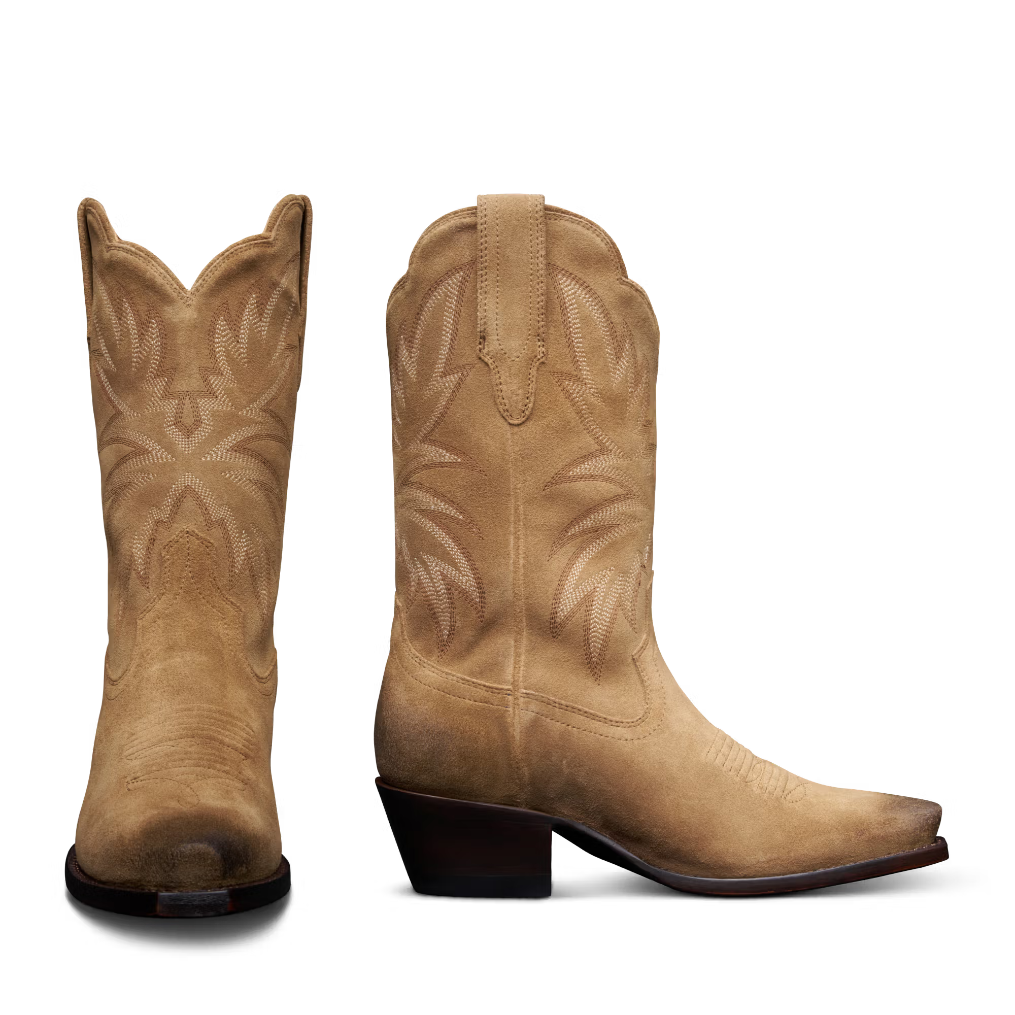 Pair of tan cowboy boots on a white background