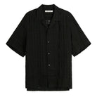 Black short-sleeve shirt on a white background