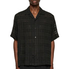 Man wearing a black checkered shirt against a white background
