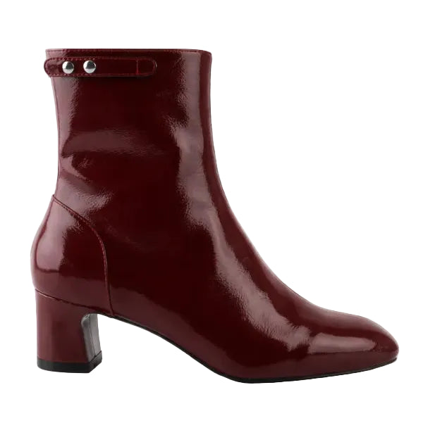 Patent leather ankle boot on a white background