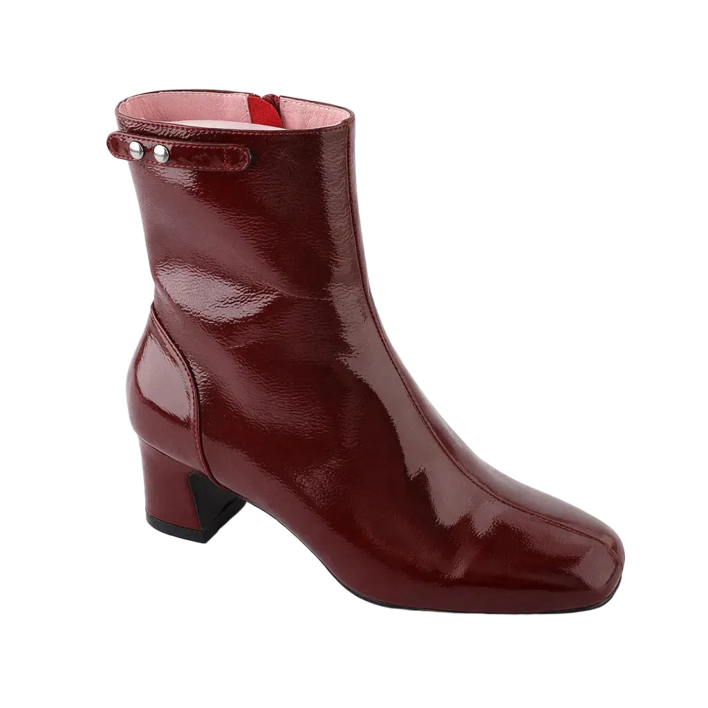 Shiny burgundy ankle boot on a white background