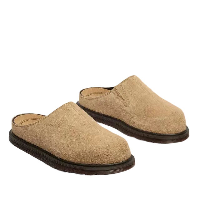 Tan mules on a white background