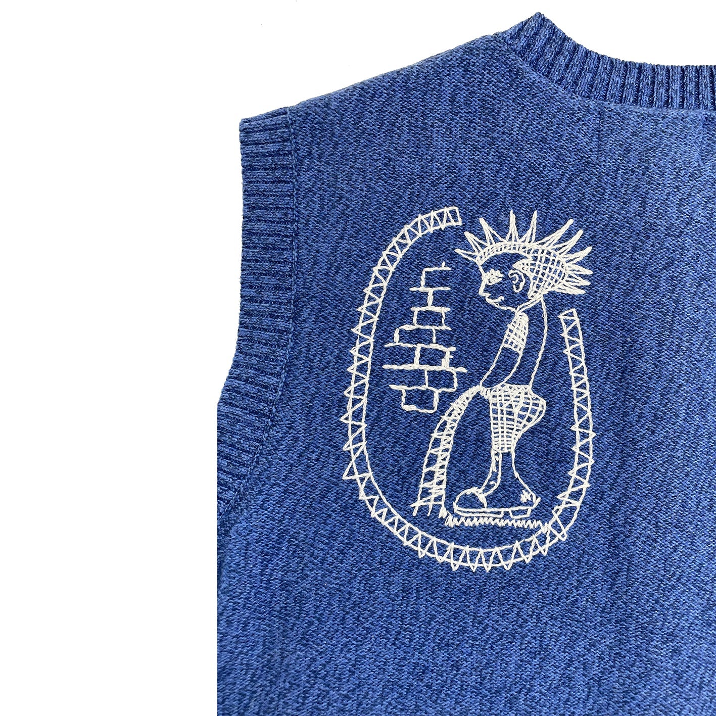 Blue sweater with white embroidered design on a white background