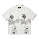 White shirt with black floral patterns on a white background