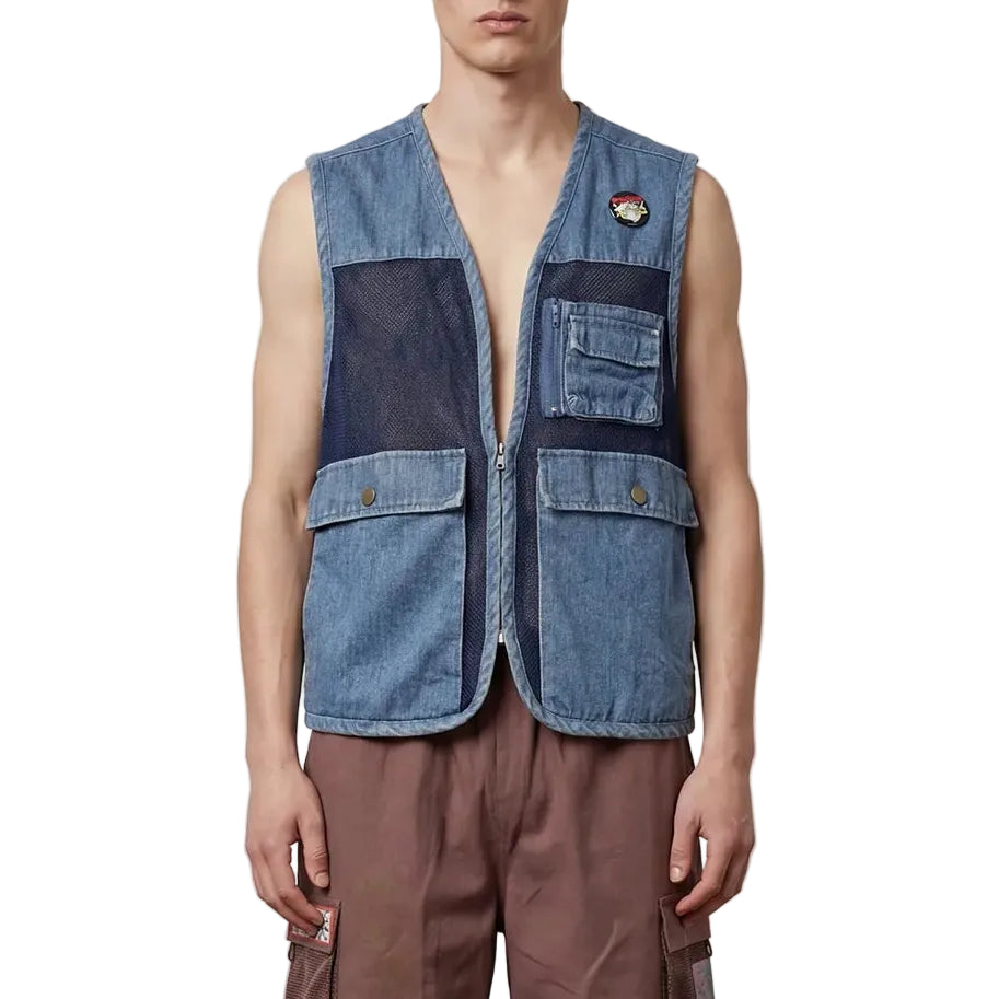Man wearing a denim vest and brown shorts on a plain background