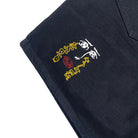 Embroidered design on a black fabric background
