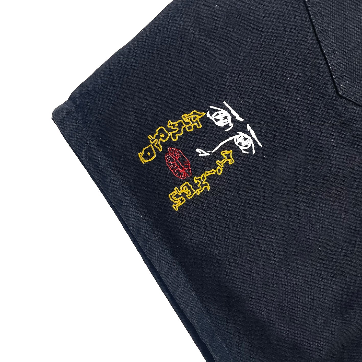Embroidered design on a black fabric background