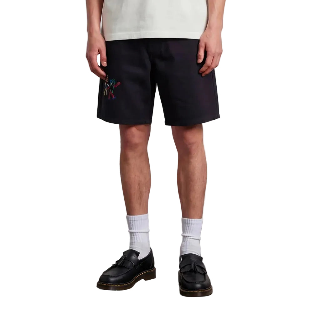 Man wearing a white t-shirt and black shorts standing against a plain background