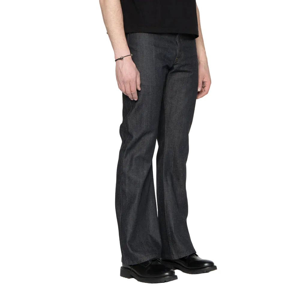 Person wearing dark blue jeans on a white background