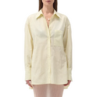 Model in a yellow shirt with pinstripes on a white background