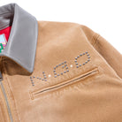 Close-up of a tan jacket with decorative elements on a white background