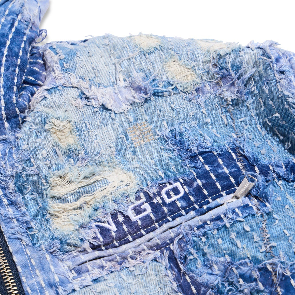 Close-up of a blue denim jacket with visible branding.