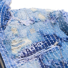 Close-up of a blue denim jacket with visible branding.