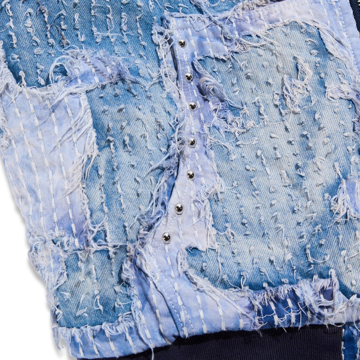Close-up of textured blue fabric with a zipper