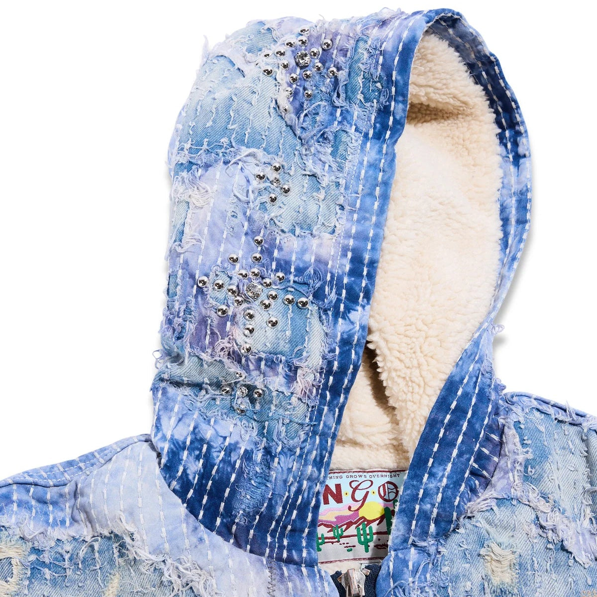 Blue distressed denim jacket with a hood on a white background