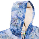 Blue distressed denim jacket with a hood on a white background