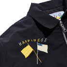 Black jacket with embroidered flags and 'Happiness' text on a white background