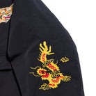 Black garment with a yellow and red dragon embroidery on a white background