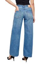 Person wearing blue jeans on a white background