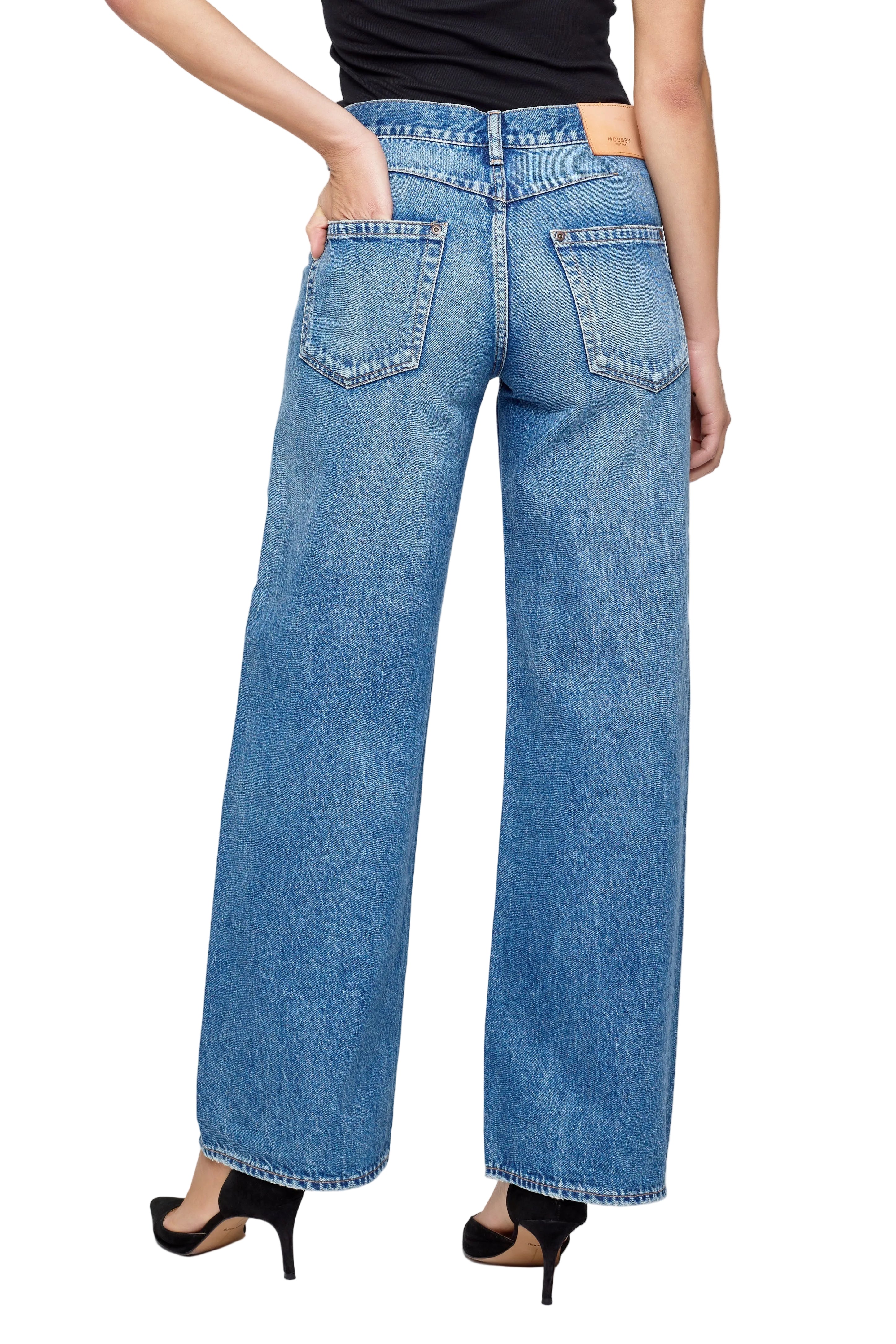 Person wearing blue jeans on a white background
