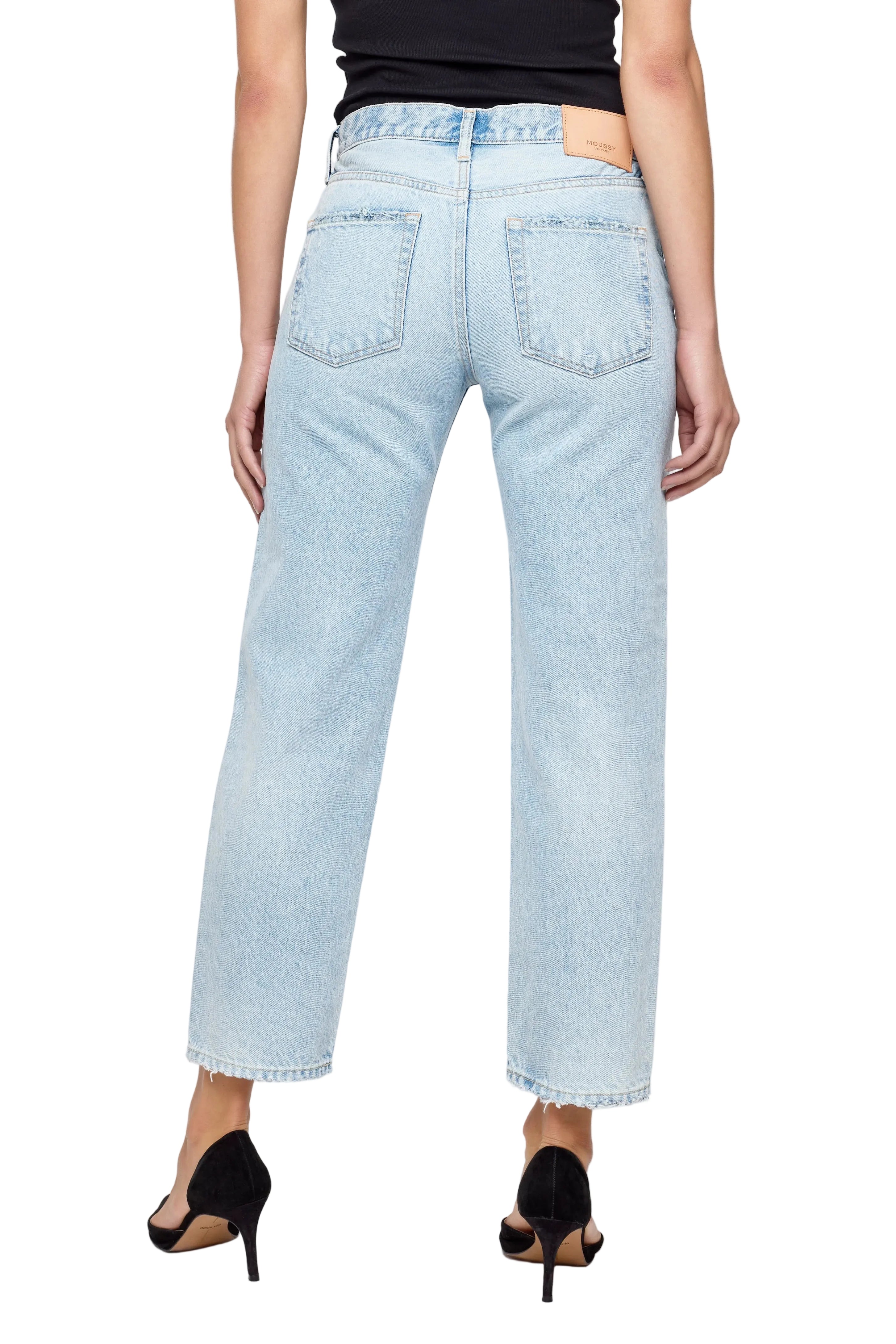 Light blue jeans worn by a person on a white background
