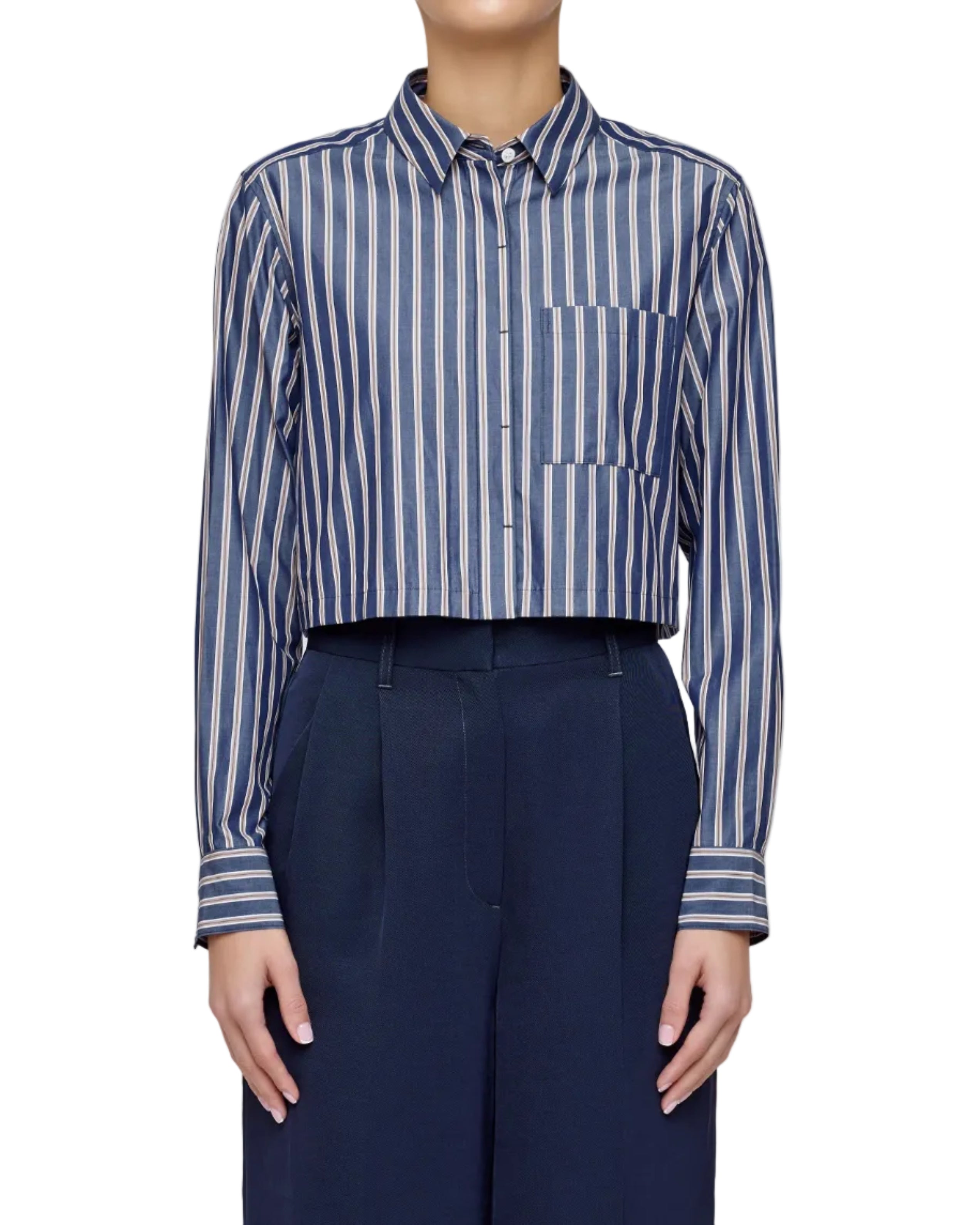 Person wearing a blue and white striped shirt with navy pants on a light gray background