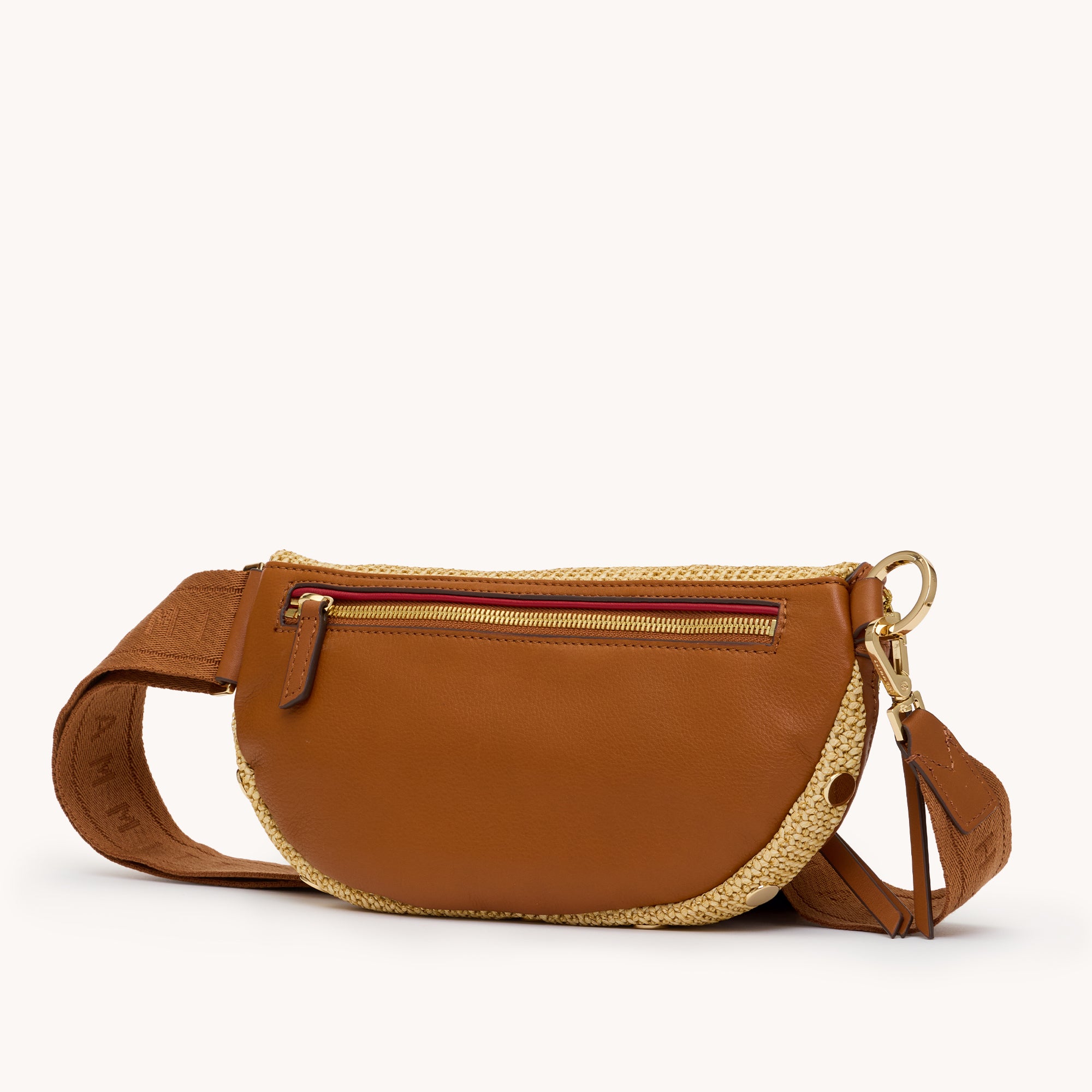 Back view of a tan crossbody bag with brown accents on a white background 