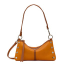 Light brown leather handbag with silver accents on a white background