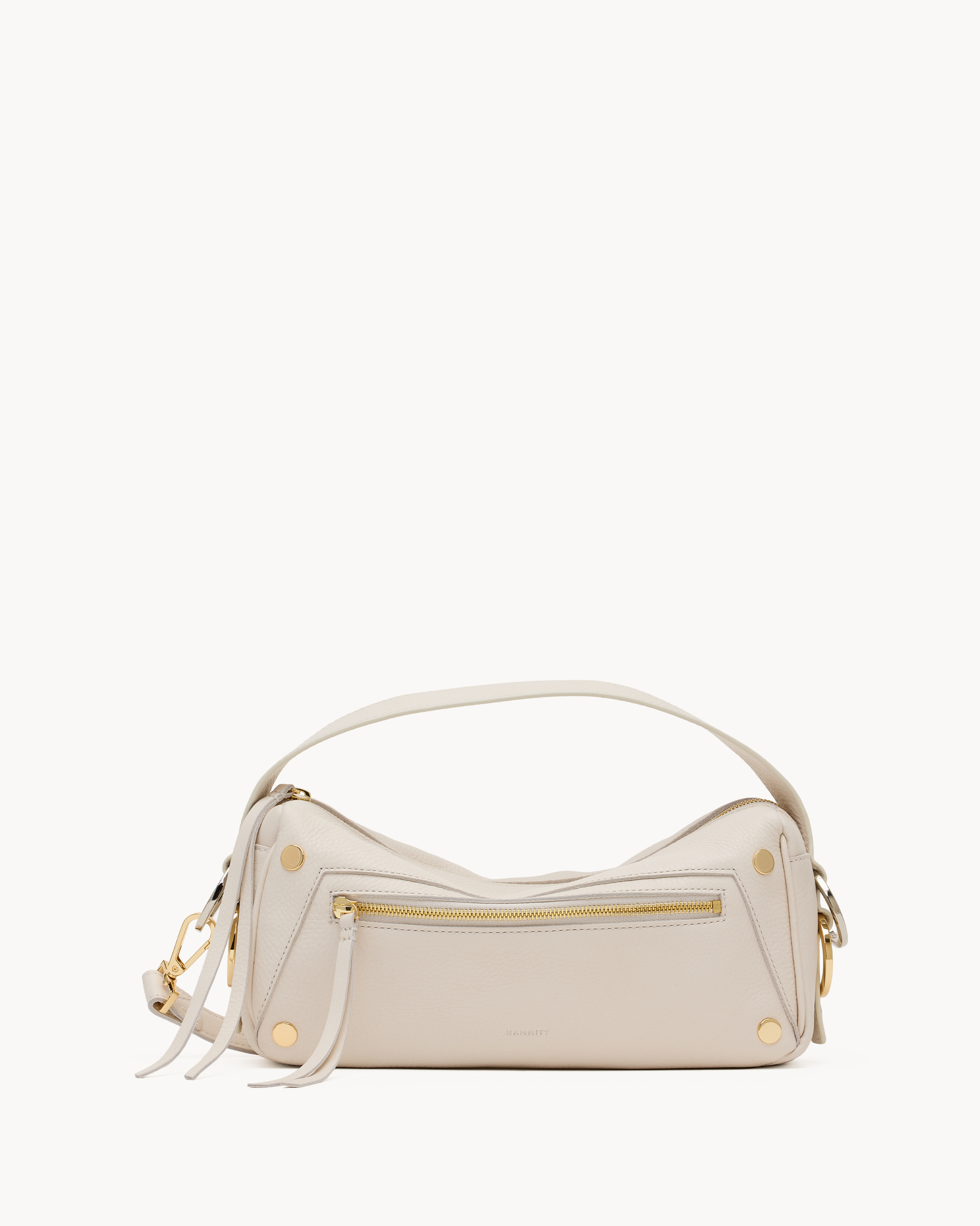 White crossbody bag with gold accents on a white background