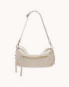 White crossbody bag with gold accents on a white background