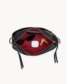 Interior view of a black handbag with gold accents on a white background