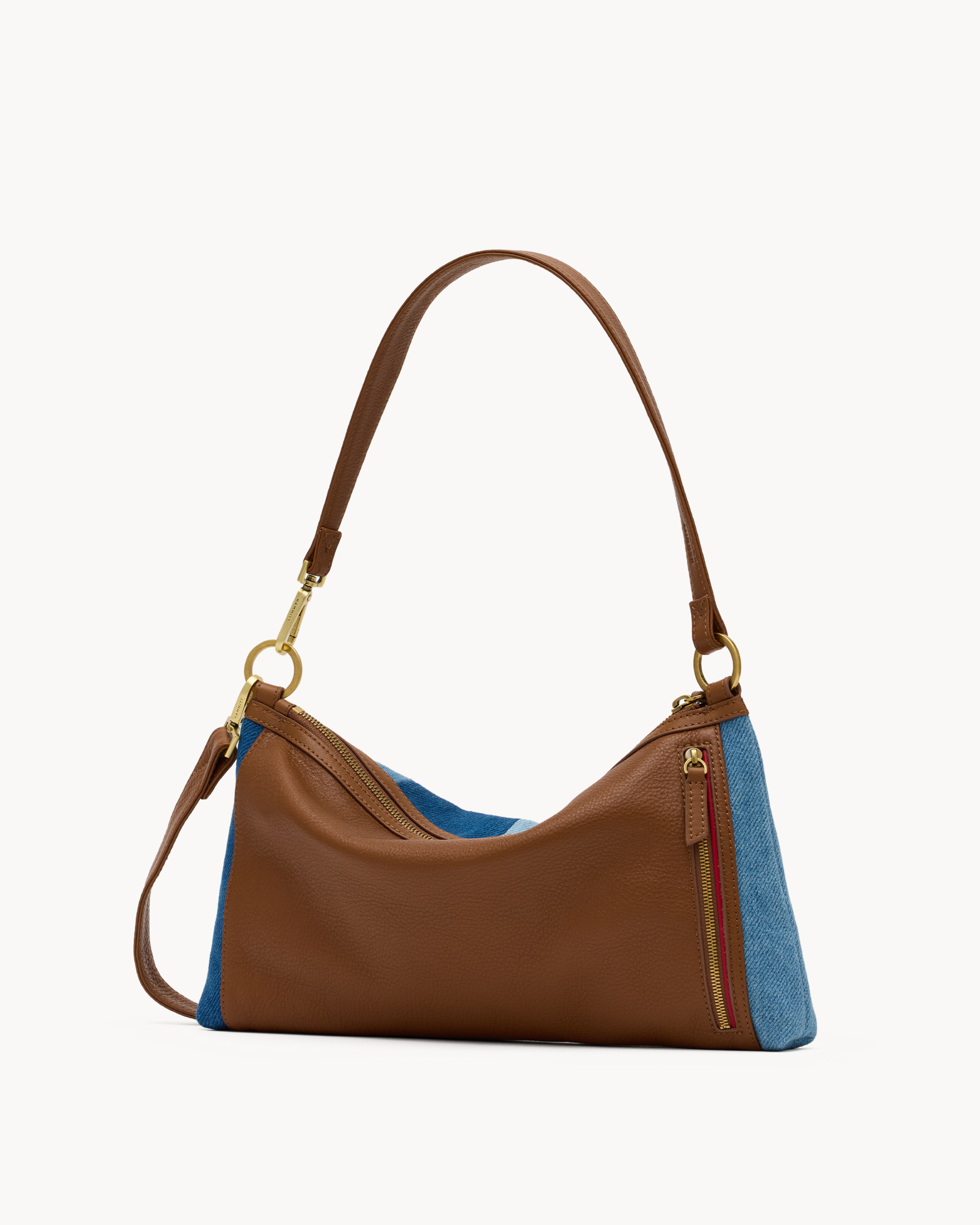 Back of a blue striped convertible bag with brown and gold accents