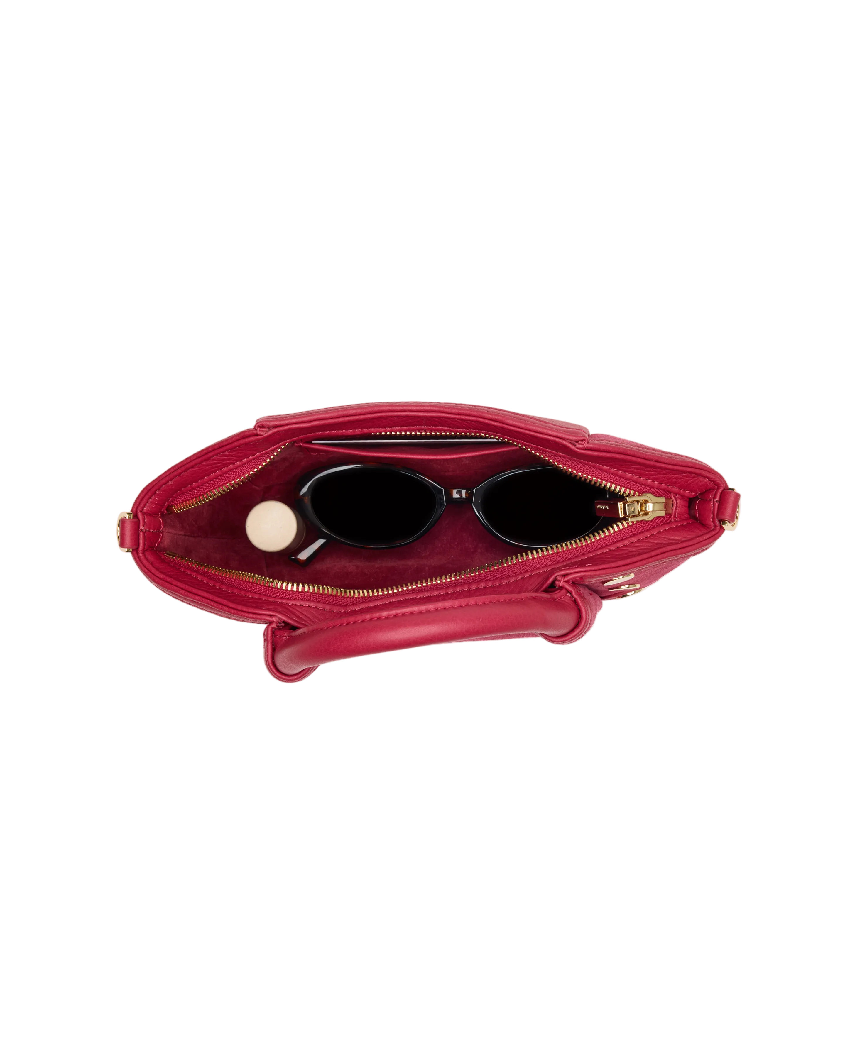 Interior view of a magenta suede convertible mini bag with gold accents on a white background