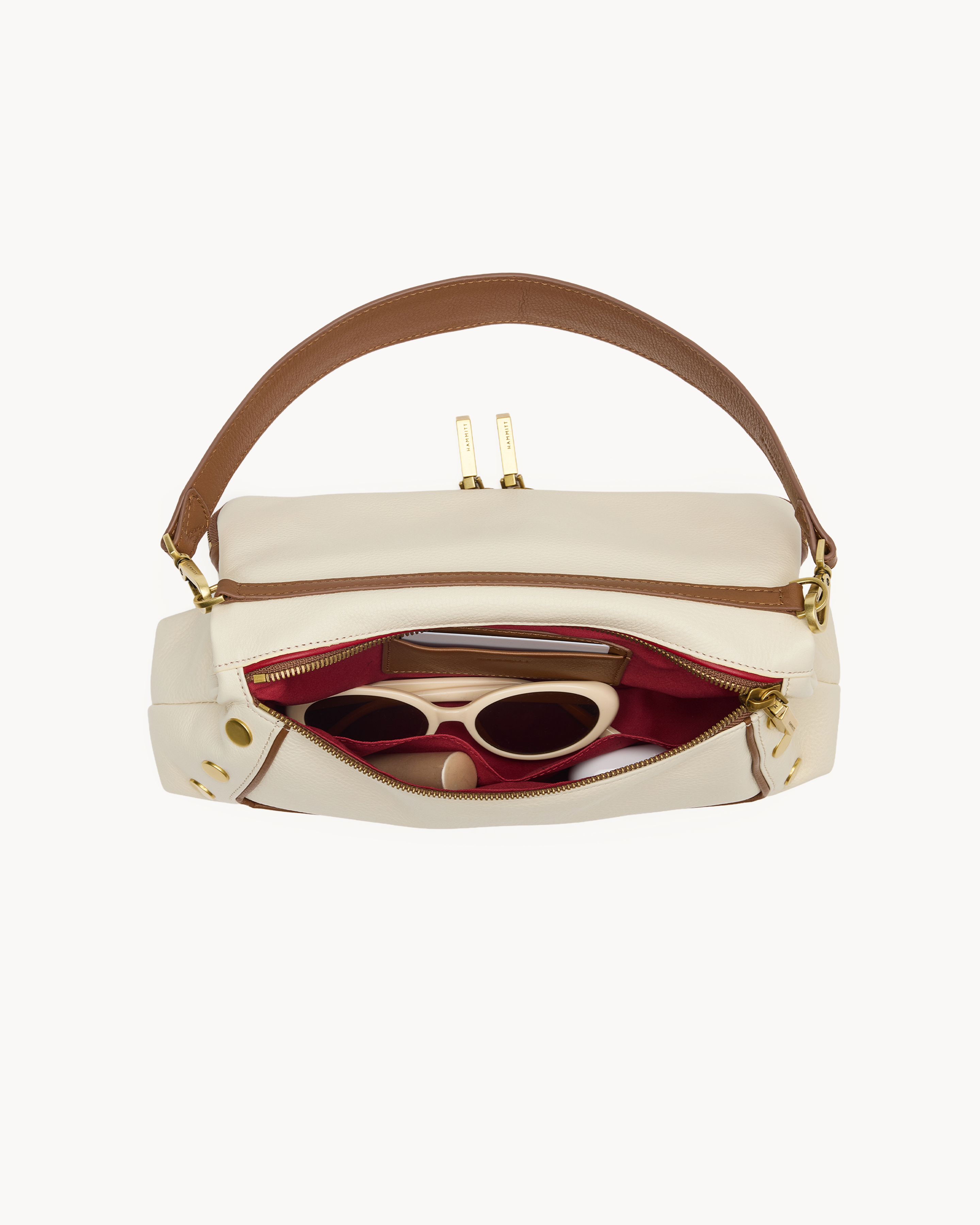 Interior view of a cream purse with brown trim on a white background