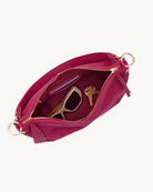 Interior view of a Pink suede handbag with gold accents on a white background