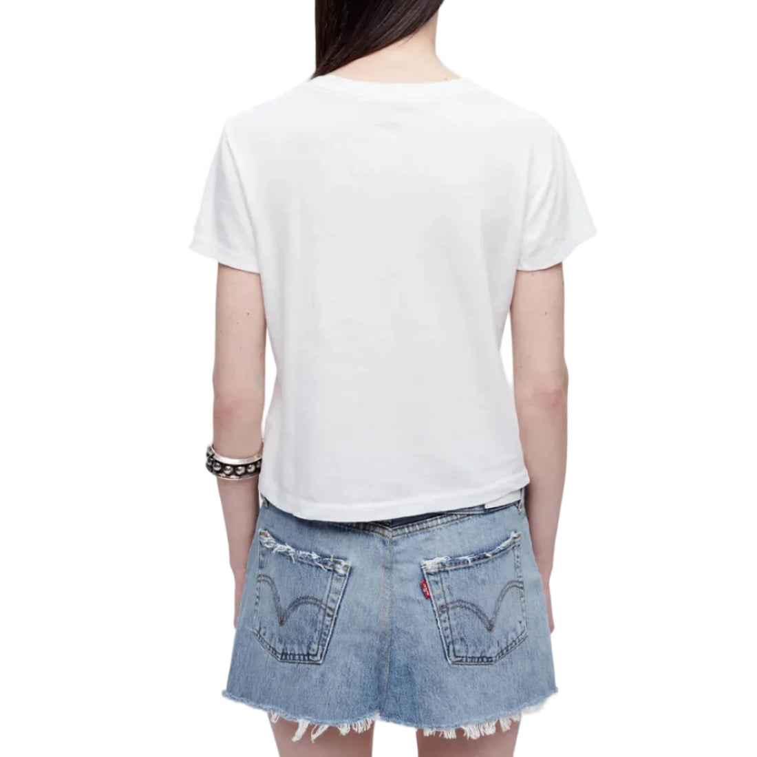 Model in a white t-shirt and denim skirt on a white background