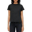 Model in a black t-shirt and black jeans on a white background