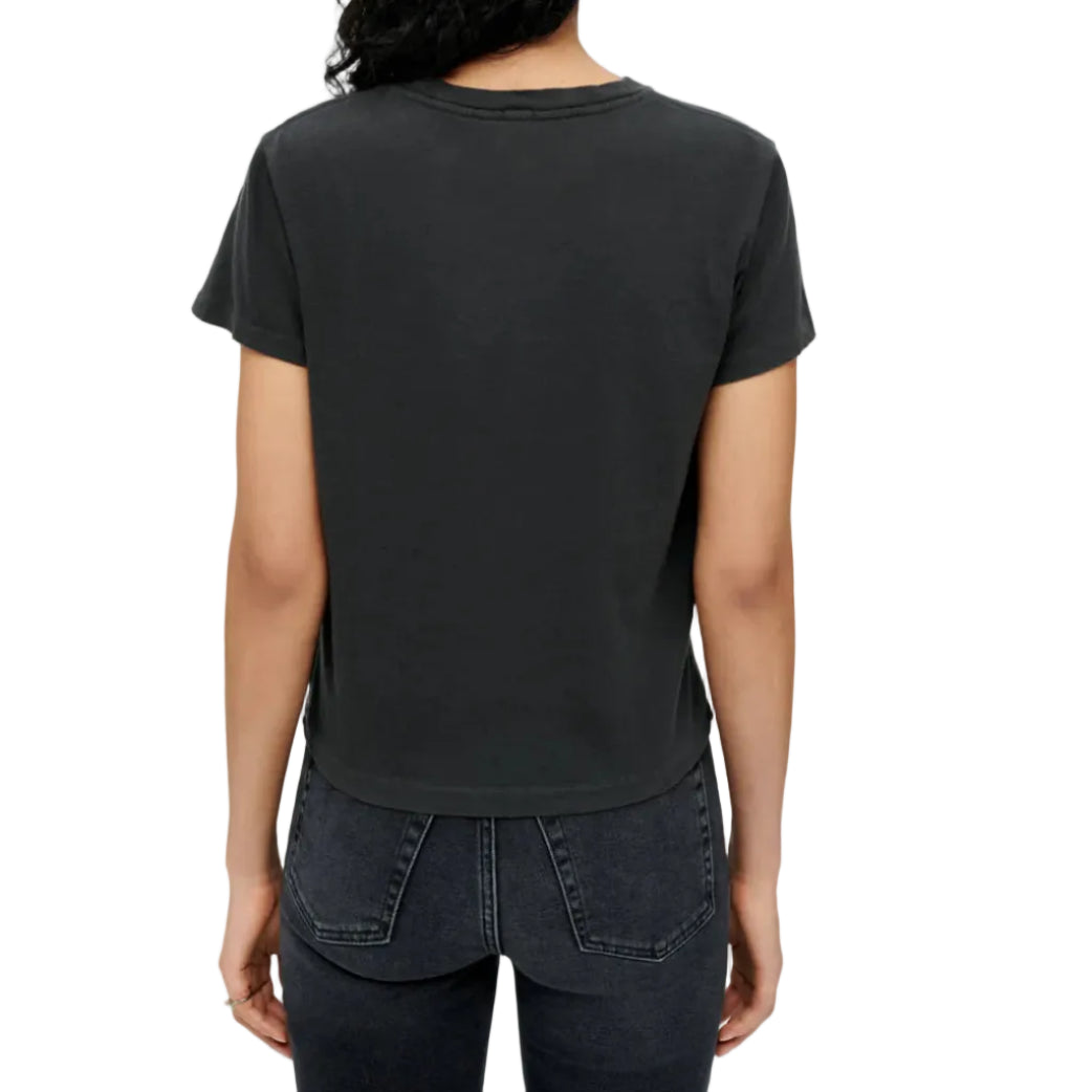 Model in a black t-shirt and black jeans on a white background