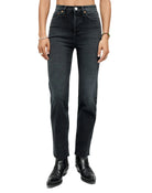 Model wearing faded black jeans on a white background