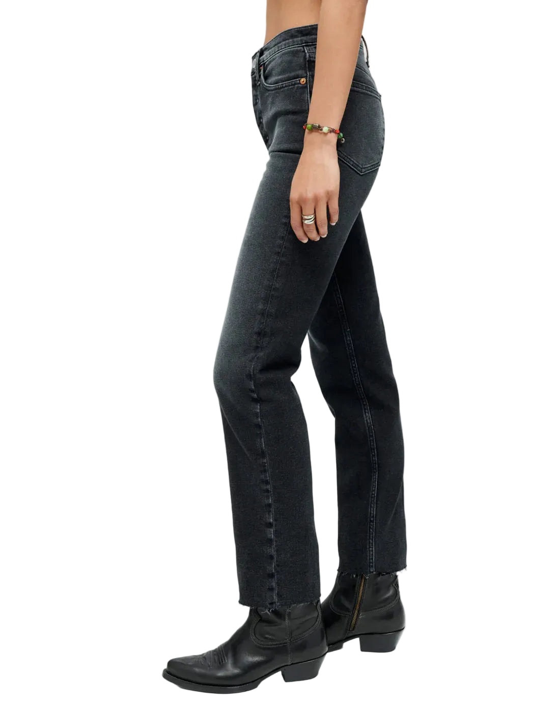 Side view of model in faded black jeans on a white background