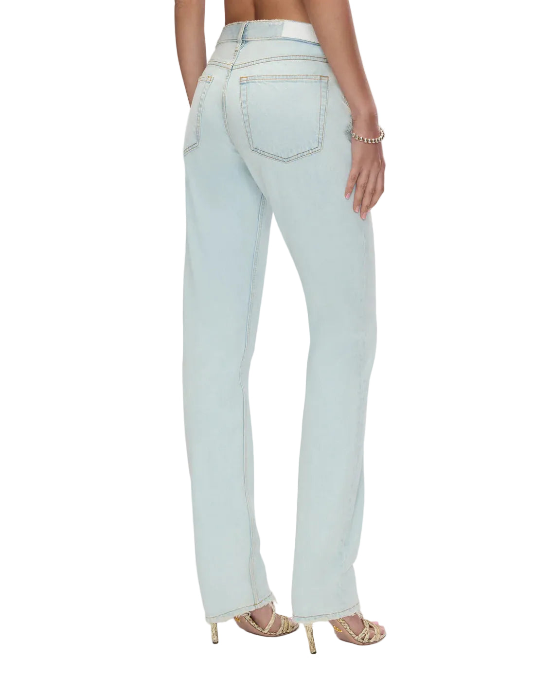 Model in light blue jeans on a white background