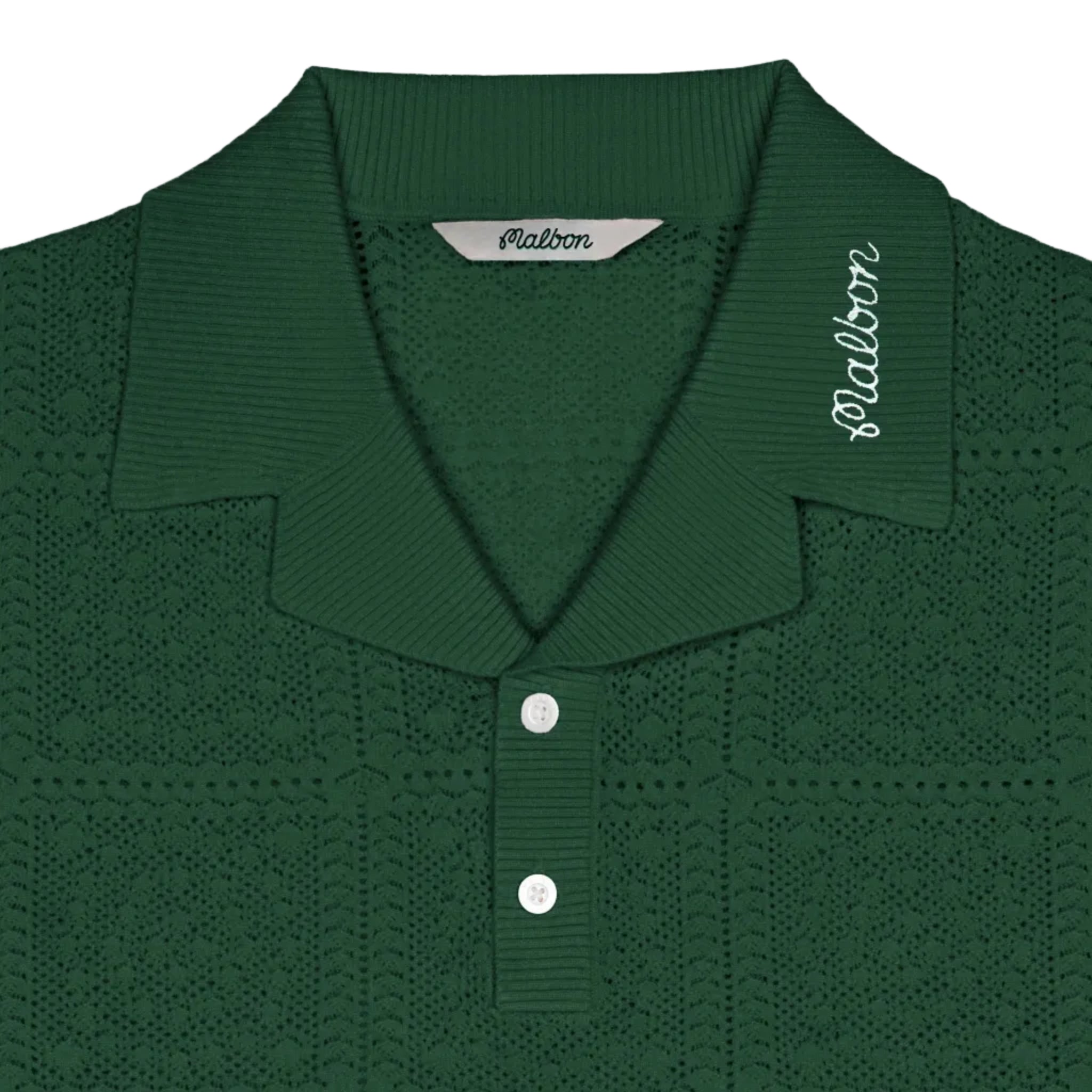 Green knitted polo shirt with brand label on a white background