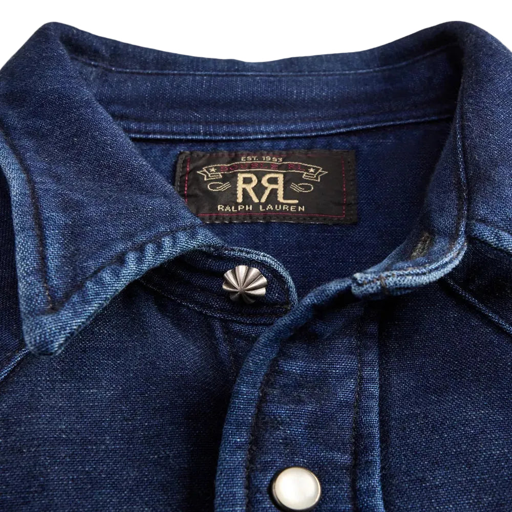 Close-up of a blue denim jacket with Ralph Lauren logo and button details.