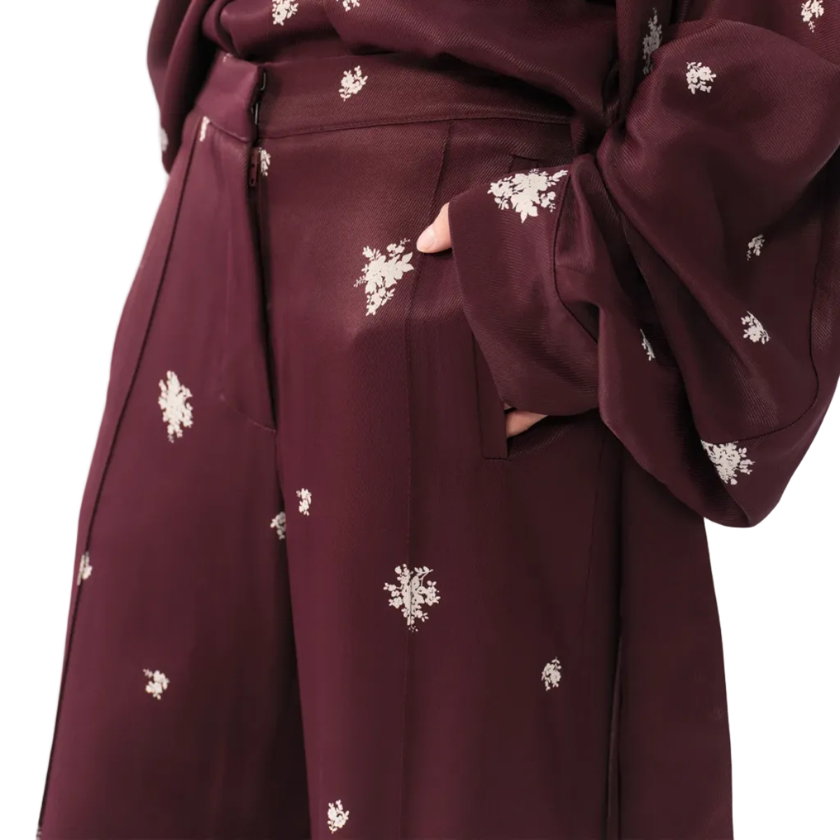 Maroon outfit with white floral patterns on a plain background