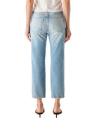 Person wearing a white t-shirt and light blue jeans on a white background