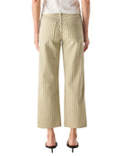 Person wearing a white top and striped pants on a white background