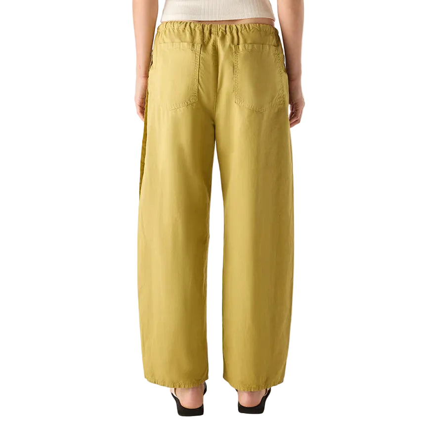 Person wearing a white top and mustard yellow pants on a white background